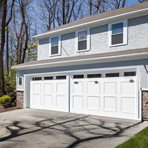 Suburban Bernardsville home exterior with a modern sectional garage door visible, driveway and seasonal trees