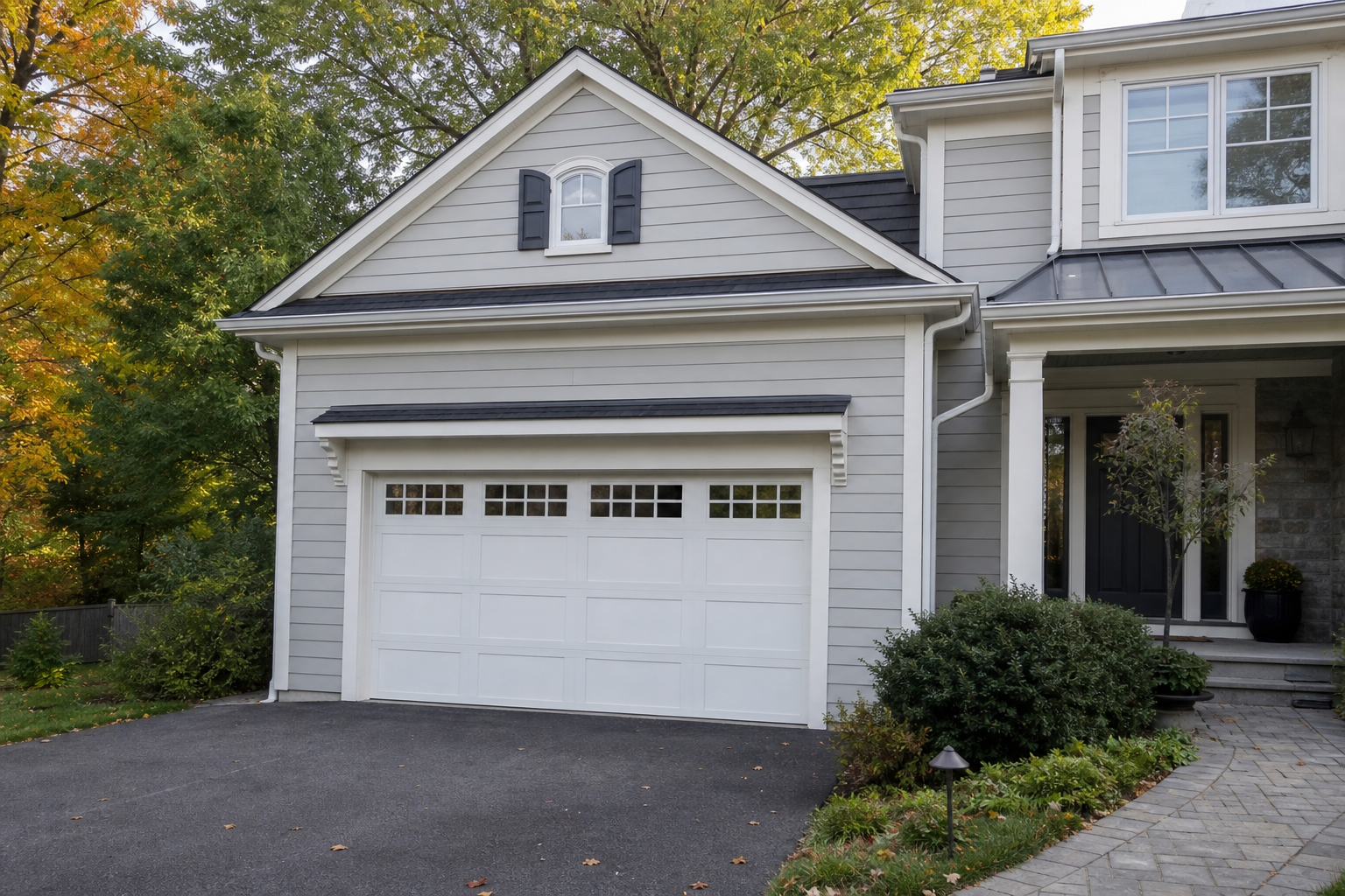 Suburban Bernardsville home exterior with a visible garage door in seasonal light